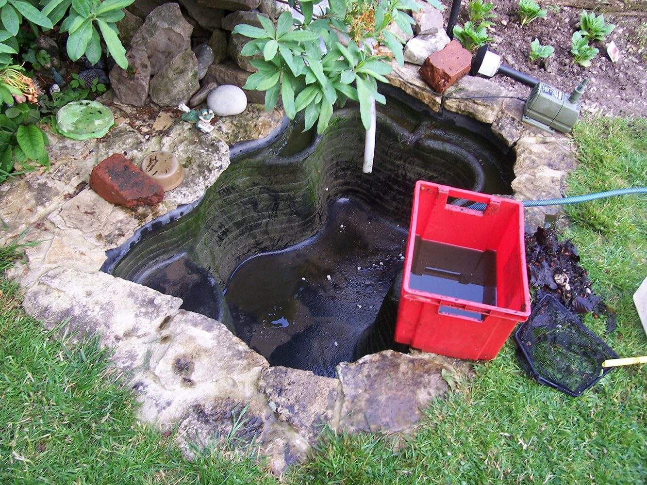 cleaning a small black pond